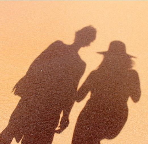 Couple shadowed on sand